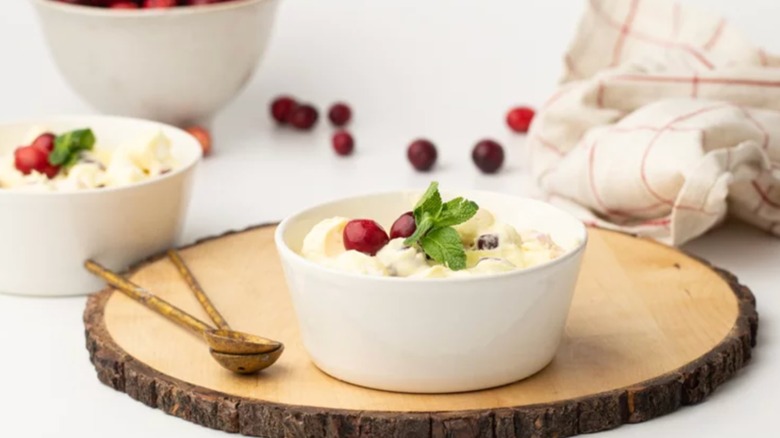 Bowl of cranberry fluff on a tree stump slice