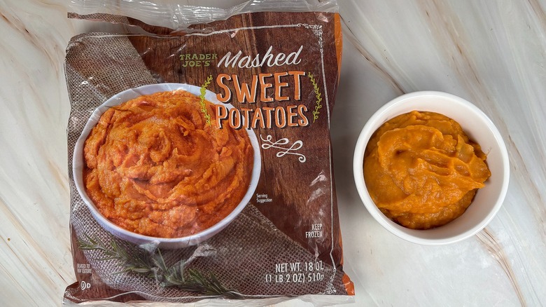 Trader Joe's Mashed Sweet Potatoes next to packaging on marbled surface