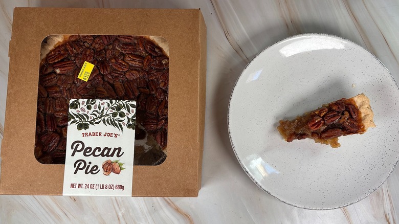 Trader Joe's Pecan Pie slice next to packaging on marbled surface