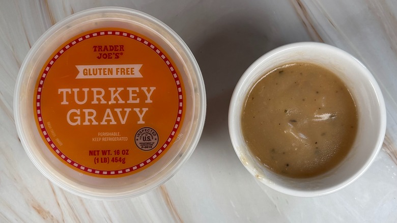 Trader Joe's Turkey Gravy in white bowl next to packaging on marbled surface