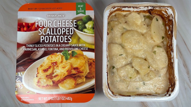 Trader Joe's Four Cheese Scalloped Potatoes next to packaging on marbled surface