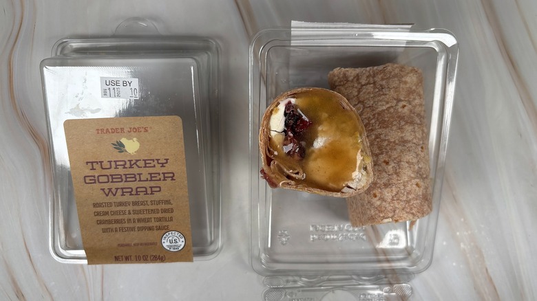 Trader Joe's Turkey Gobbler Wrap next to packaging on marbled surface