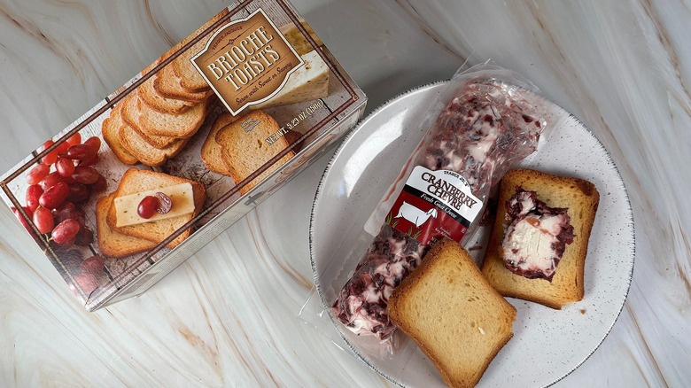 Trader Joe's Brioche Toasts and Cranberry Chevre next to each other on table