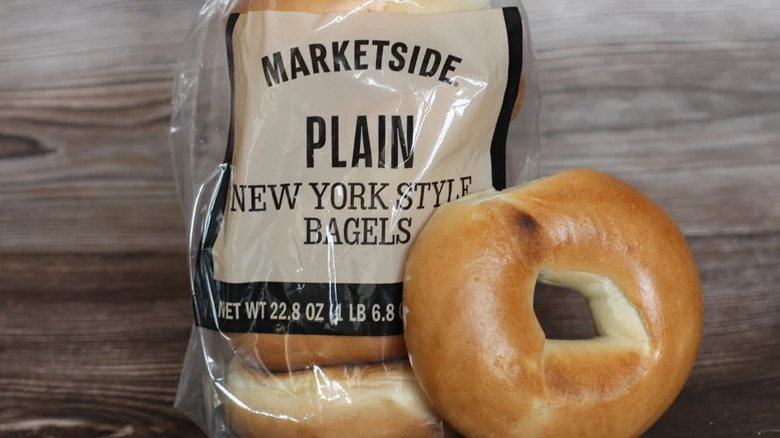 Package of Marketside New York style bagels with one bagel out of the bag
