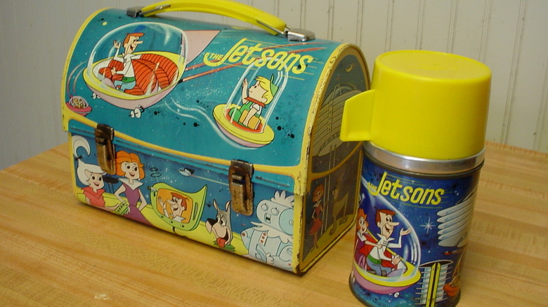 "The Jetsons" lunchbox and thermos from 1963 on a wooden table