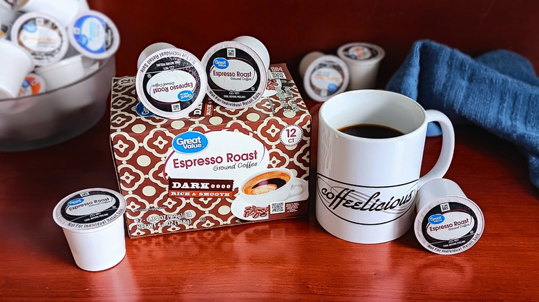 Great Value Espresso Roast coffee pod box, surrounded by loose pods and a mug of black coffee