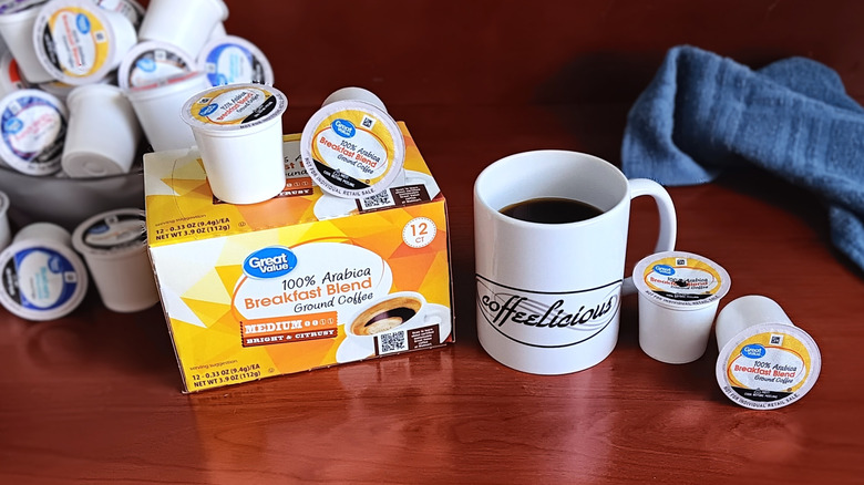 Great Value Breakfast Blend coffee pod box, surrounded by loose pods and a mug of black coffee