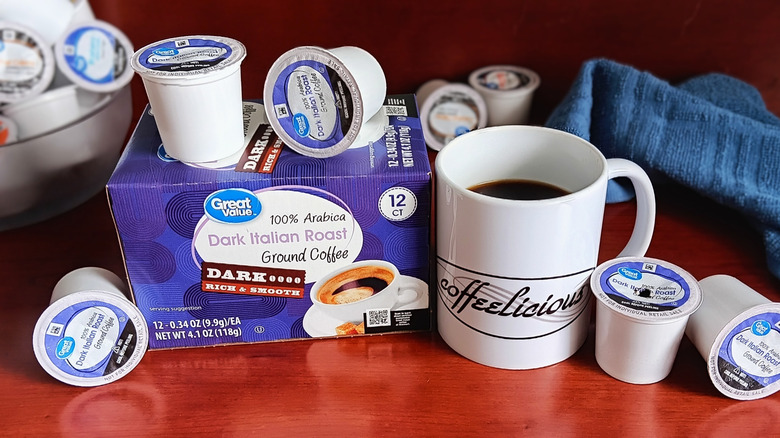Great Value Dark Italian Roast coffee pod box, surrounded by loose pods and a mug of black coffee