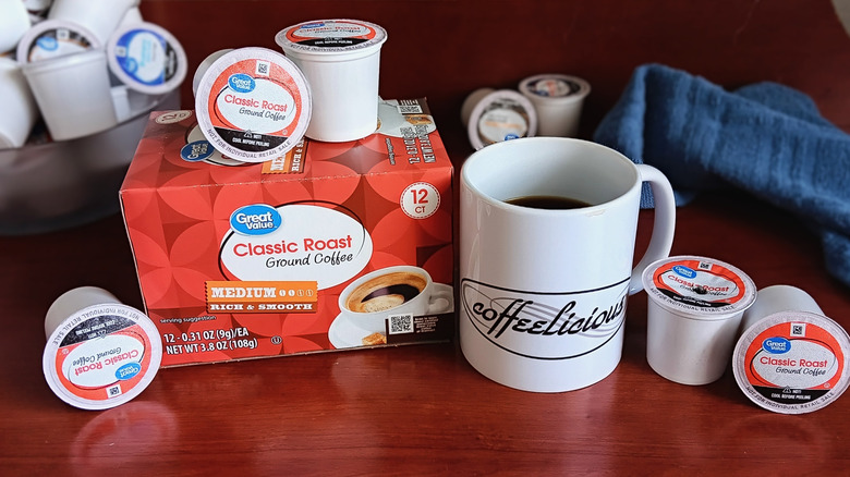Great Value Classic Roast coffee pod box, surrounded by loose pods and a mug of black coffee
