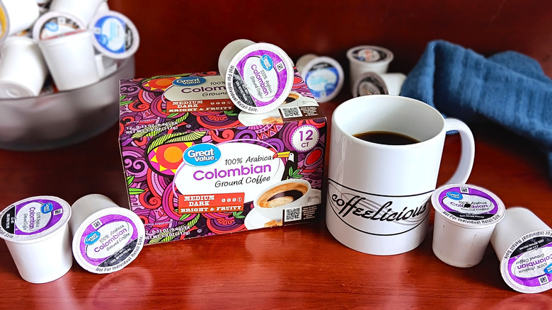 Great Value Colombian coffee pod box, surrounded by loose pods and a mug of black coffee