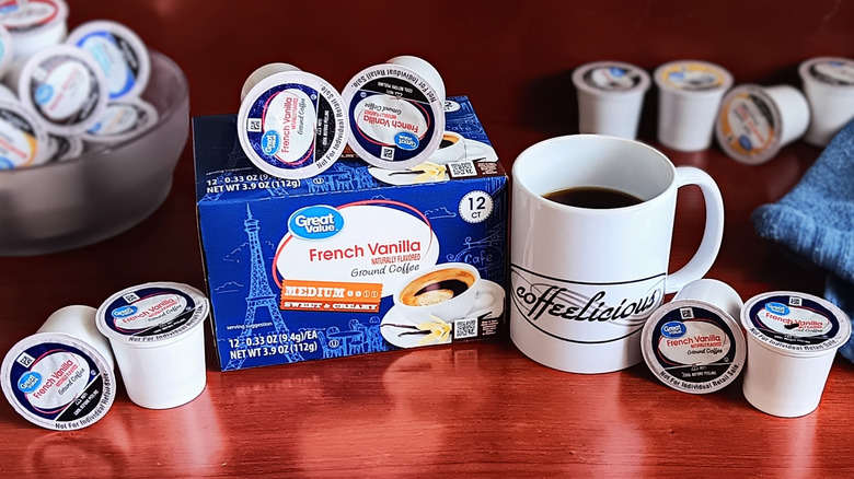 Great Value French Vanilla coffee pod box, surrounded by loose pods and a mug of black coffee