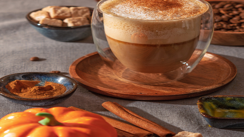 Spiced milk foam on a latte in a clear glass