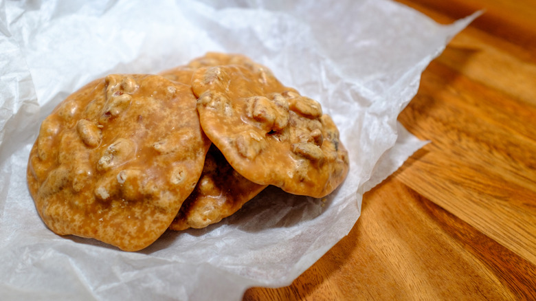 Three praline candies on wax paper