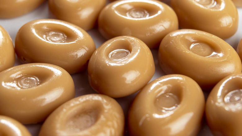 A close-up of round butterscotch candies filling the frame