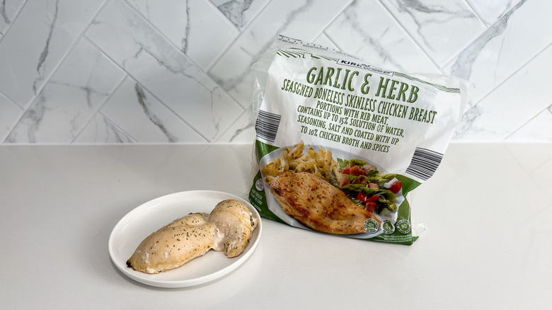 Kirkwood garlic & herb chicken breast on a plate with product bag alongside