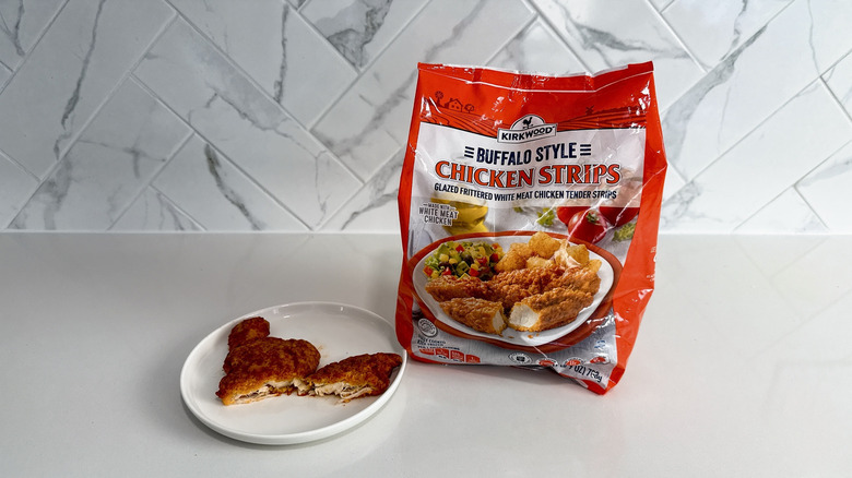 Kirkwood Buffalo style chicken strips on a plate with product bag alongside