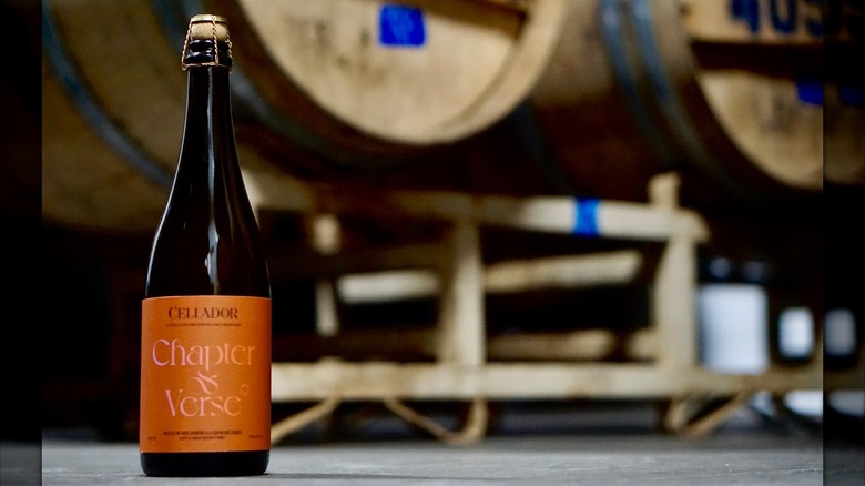 Bottle of Chapter & Verse in front of barrels