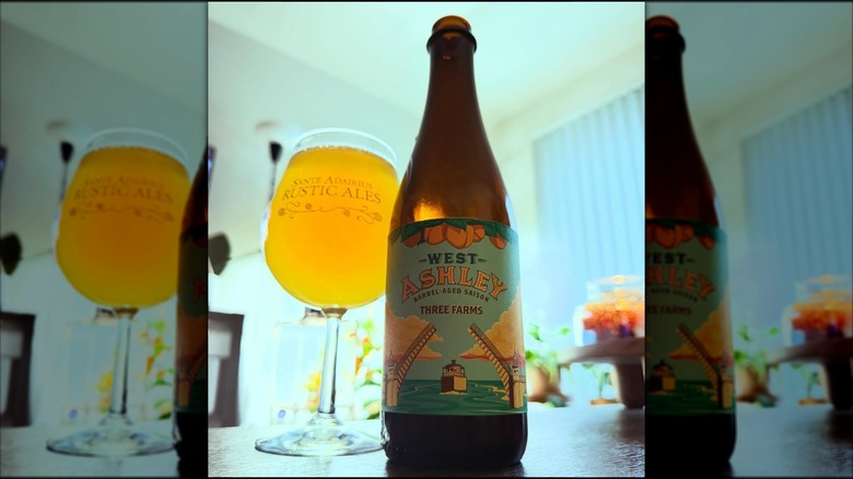Bottle of West Ashley next to a full beer glass