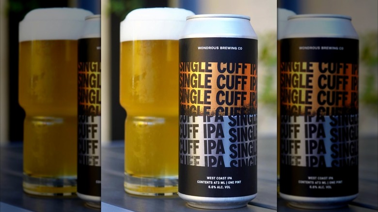 Can of Single Cuff next to a full glass