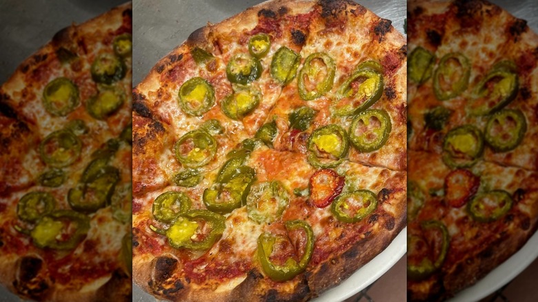 a pizza with jalapeños