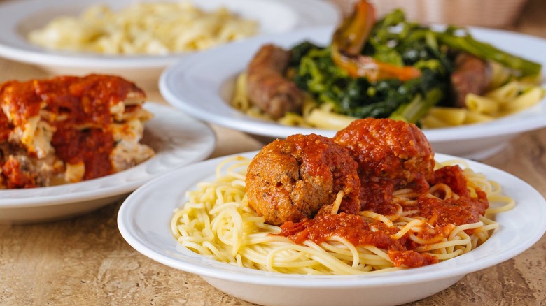 spaghetti and meatballs dishes on a table