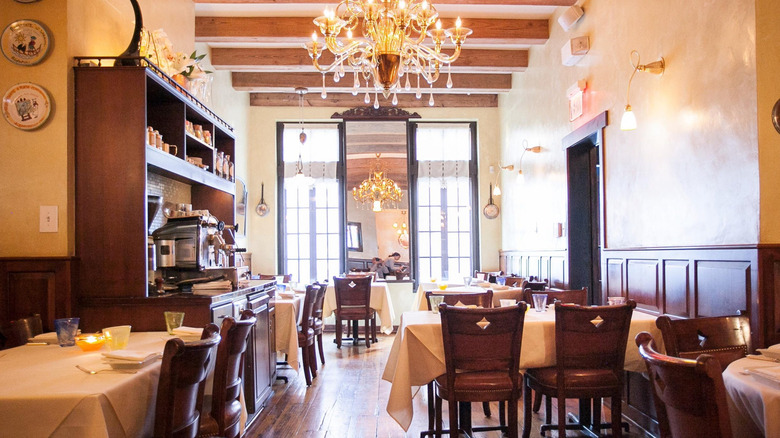 interior of Vetri Cucina restaurant with white tablecloths covering tables