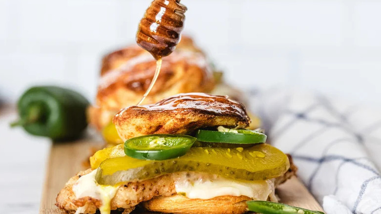 Hot Honey Chicken Biscuit Sandwiches on wooden cutting board
