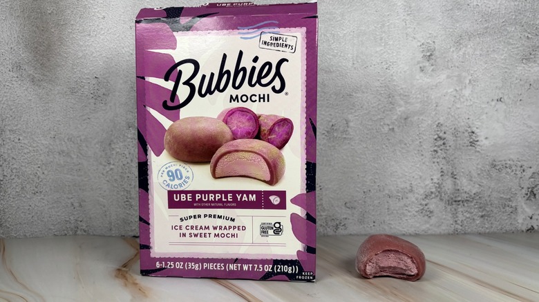 Bubbies Ube Purple Yam mochi box next to mochi with bite taken out of it on table