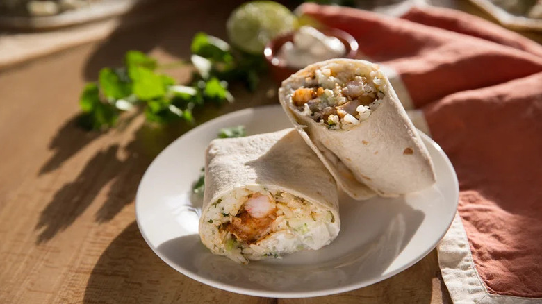 Blackened Shrimp Burritos on white plate in sunshine