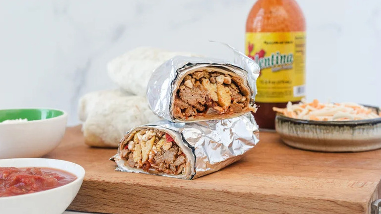 Make-Ahead, High-Protein Breakfast Burrito in foil on wooden board