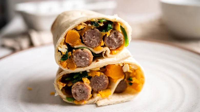 Sausage and Butternut Squash Breakfast Burrito stacked on white plate