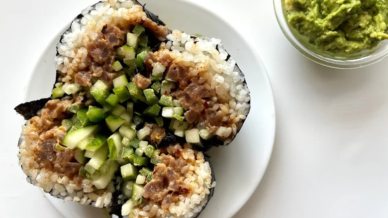 Spicy Tuna Sushi Burrito cut open on white plate