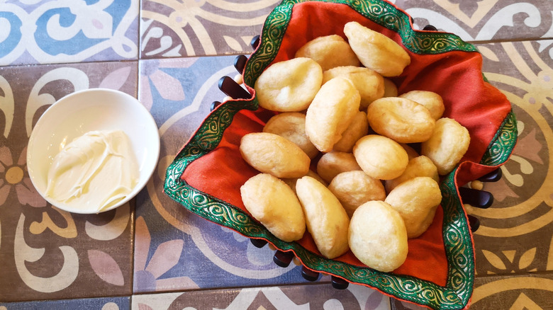 Borsok fried dough pieces in bowl lined with red and green patterned napkin