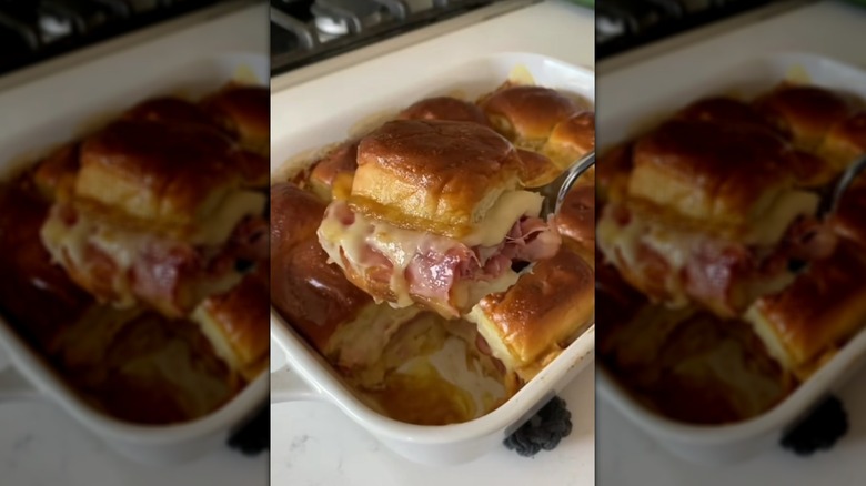 Lifting cheese and ham slider out of baking dish