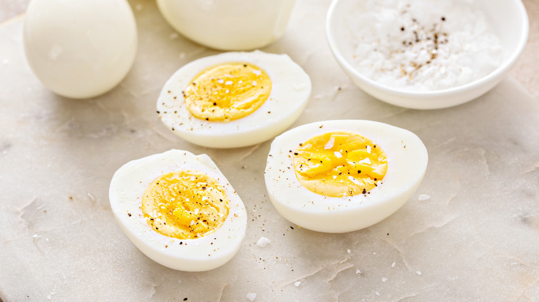 Halved hard-boiled eggs sprinkled with salt and pepper
