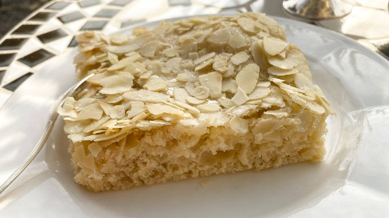 Slice of traditional German zuckerkuchen cake, topped with slivered almonds