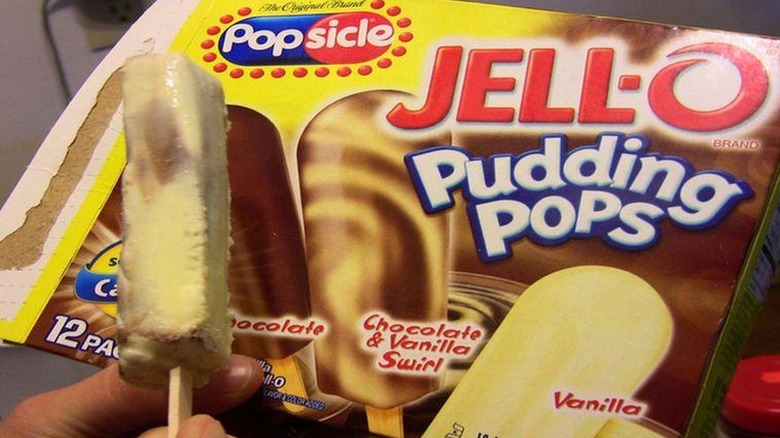 A chocolate and vanilla swirl Pudding Pop in front of box of Jell-O Pudding Pops.