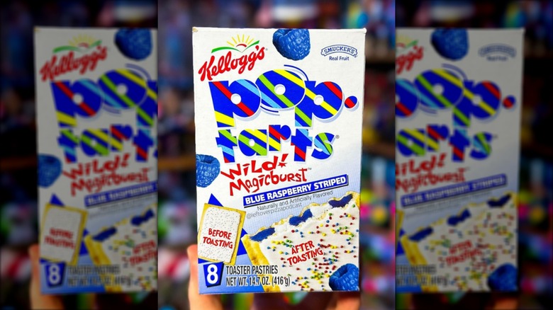 A hand holding a box of Wild Magicburst Pop-Tarts.