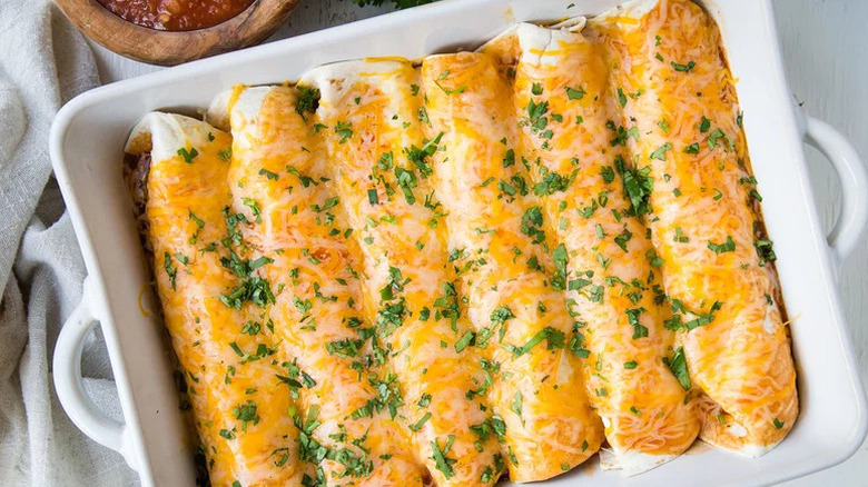 Loaded Beef Enchilada in white casserole dish