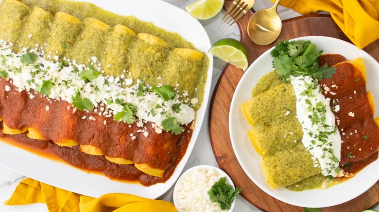Seafood Enchiladas Divorciadas in white baking dish and on white plate