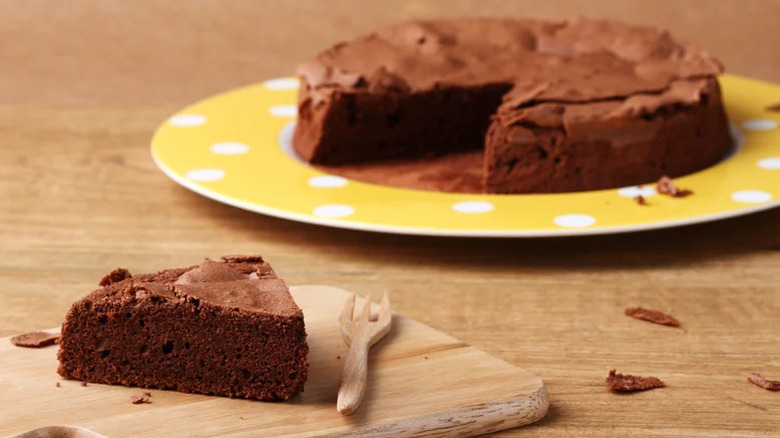 Depression cake slice on cutting board and yellow plate