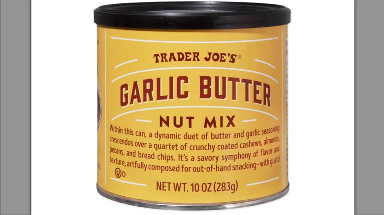 Yellow canister of Trader Joe's Garlic Butter Nut Mix on white background