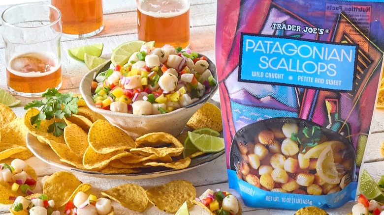 Bag of Trader Joe's Patagonian Scallops next to tortilla chips and bowl of scallop salsa on plate, beer behind