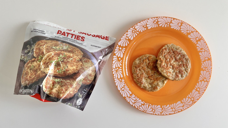 Two Trader Joe's Chicken Breakfast Sausage Patties on a plate with a whole bag next to it