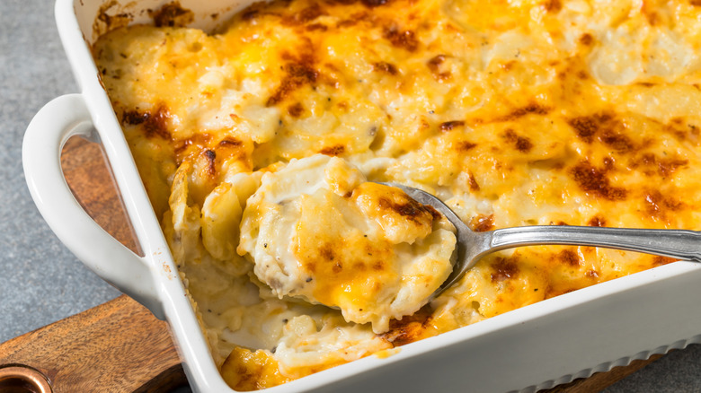 Cheesy scalloped potatoes in baking dish