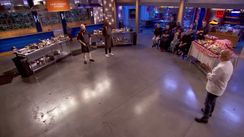 Top Chef contestants being judged by Tom Colicchio