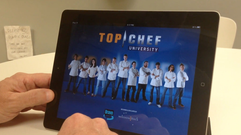 Hands holding tablet with Top Chef University app
