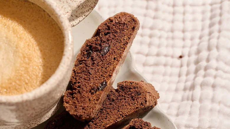 Chocolate biscotti beside a cup of coffee