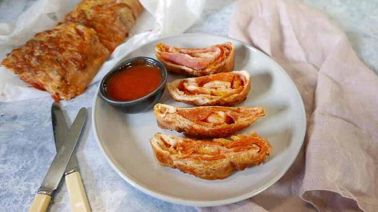 Plate of sliced stromboli with marinara