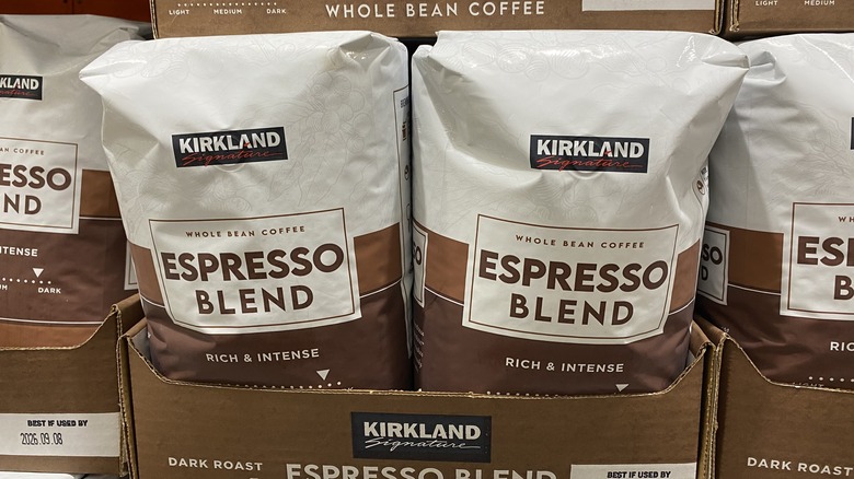 Bags of Kirkland Signature espresso blend whole bean coffee sitting in cardboard boxes